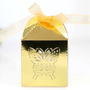 Detailed view of golden butterfly hollow candy box with yellow satin bow decoration