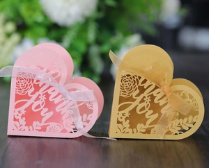 Detailed laser-cut heart favor boxes with Thank You motif and elegant organza ribbons