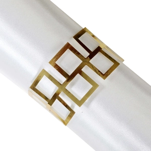 Modern gold geometric napkin ring with square hollow design on white satin napkin