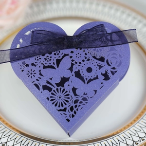 Close-up of purple heart-shaped candy box with laser-cut butterfly lace and ribbon