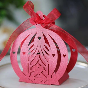 Detailed laser-cut heart pattern on a red pearlescent cardstock wedding candy box