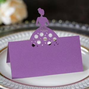 Detail of laser-cut purple table card featuring an elegant female silhouette design