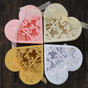 Detailed laser-cut heart favor boxes with Thank You text and elegant organza ribbons
