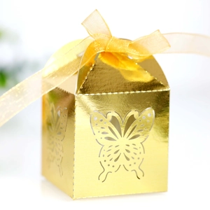Detailed butterfly laser-cut gift box in metallic gold with an elegant satin ribbon bow
