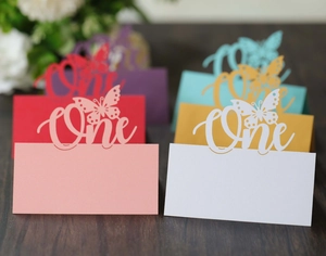 Close-up of laser-cut butterfly one birthday table cards in various assorted colors