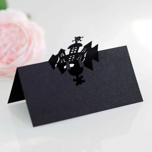 Halloween table place cards featuring laser-cut black castle and skull designs