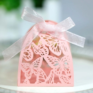 Close-up of laser-cut pink butterfly candy box with an elegant white organza ribbon bow