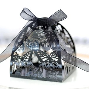 Detail of laser-cut butterfly gift box with elegant black organza ribbon bow