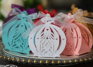 Detail of laser-cut pumpkin carriage candy boxes with elegant ribbons and heart patterns