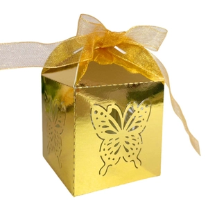 Detailed view of laser-cut butterfly patterns on a metallic gold candy gift box with ribbon