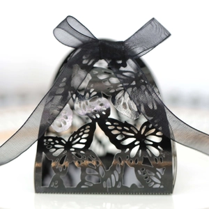 Macro shot of black laser-cut butterfly gift box with delicate organza ribbon detail