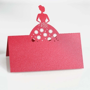 Close-up of red glitter laser-cut rose girl place card with delicate flower details