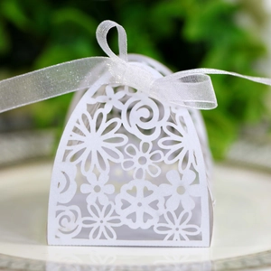 Detailed laser-cut floral pattern on white gift box with elegant satin ribbon bow