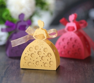 Detail of laser-cut rose hollow candy boxes in gold, purple and rose pearlescent paper