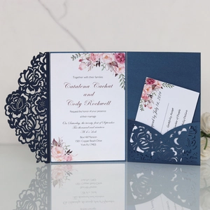 Detail of navy blue laser-cut floral wedding invitation with RSVP card and flower pattern
