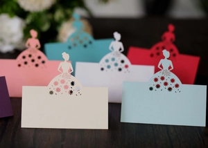 Detailed laser-cut floral wedding place cards with elegant bride silhouette in multiple colors