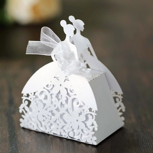 Detail of laser-cut flower patterns and mesh bow on white hollow candy box