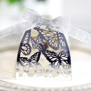 Detail of laser-cut butterfly hollow candy box with elegant silver ribbon bow