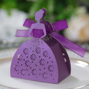 Macro shot of purple laser-cut party gift box featuring a glittery floral dress design