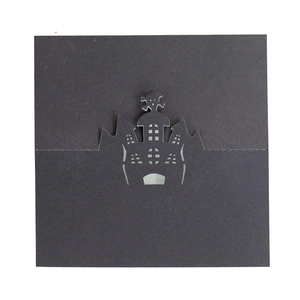 Detail showing the intricate laser-cut hollow castle design on black cardstock