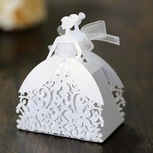 Macro shot of white laser-cut bridal dress gift box with pearlescent finish and ribbon