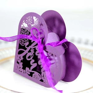 Macro detail of purple heart gift box with laser-cut lace floral pattern and Love text