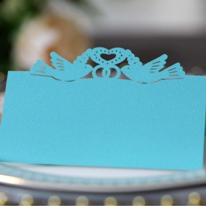 Light blue laser-cut wedding place card with love birds and heart design for table settings