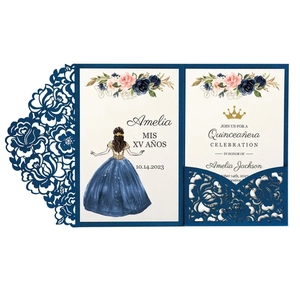 Close-up of laser cut navy blue floral wedding invitation with golden crown and inner card
