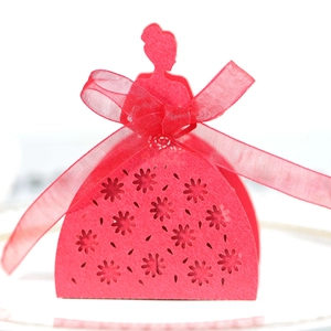Detail of laser-cut red wedding favor box with elegant girl silhouette and floral pattern