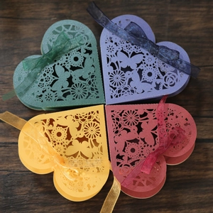 Laser cut heart shaped candy boxes with floral butterfly patterns and satin ribbons
