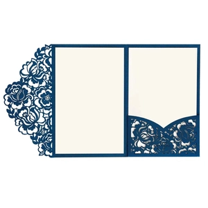 Macro view of laser-cut floral pattern and RSVP slot on navy blue wedding invitation