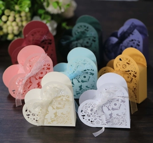 Macro shot of assorted laser-cut butterfly gift boxes with decorative silk ribbons