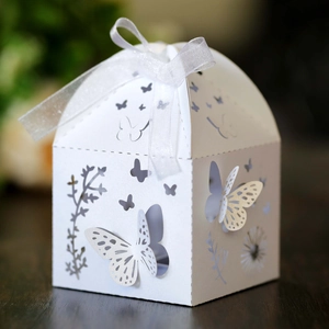 Laser cut butterfly wedding candy box in white cardstock with organza ribbon bow