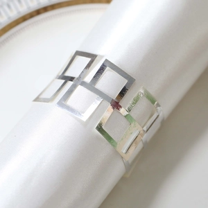 Macro shot of silver metallic napkin ring with geometric hollow square design