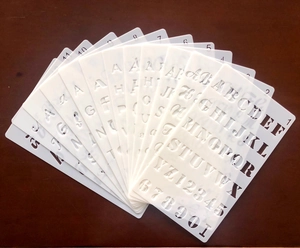 Detailed set of translucent PET plastic stencils featuring uppercase letters and numbers