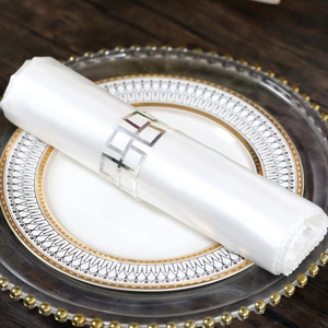 Silver geometric hollow square napkin ring shown on white napkin for wedding table decor
