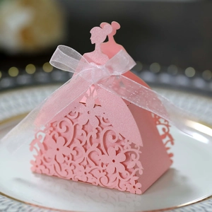 Detail view of pink laser-cut bride-shaped candy box with delicate floral patterns