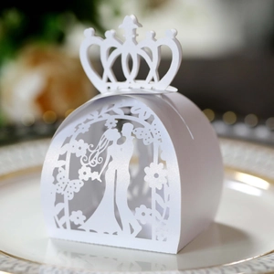 Detailed laser-cut white wedding favor box with crown top and bride groom silhouette