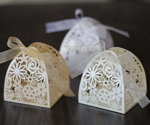 Detailed laser-cut gift box with floral patterns and sheer organza ribbon ties