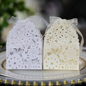 Detailed laser-cut pattern and organza ribbon on elegant blue hollow candy boxes