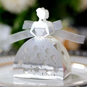 Detailed laser-cut silver dress-shaped favor box with white ribbon for wedding parties