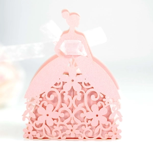 Detail of pink laser-cut wedding favor box featuring an elegant girl silhouette and white bow