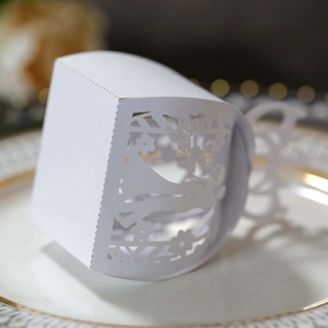 Detail of white laser-cut butterfly and floral patterns on wedding gift candy boxes