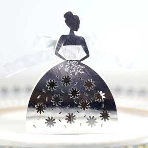 Macro detail of silver laser-cut lady silhouette candy box with daisy pattern and bow