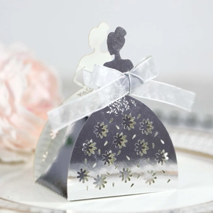 Close-up of laser-cut silver mirror bridal silhouette candy box with white ribbon bow