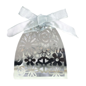Detail of silver laser-cut hollow gift box with floral patterns and a light blue satin ribbon