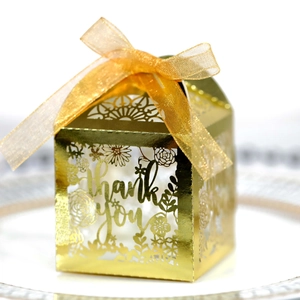 Detailed view of golden hollow gift box with Thank You cutout and satin ribbon