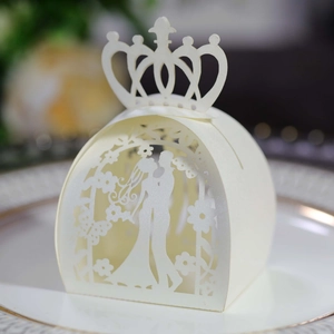 Detail of laser-cut wedding favor box with crown top and bride groom silhouette