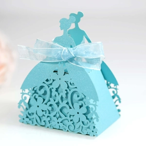 Detail of light blue laser-cut candy box featuring elegant bridal gown floral patterns