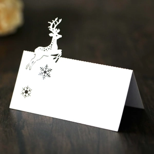 Detailed view of laser-cut reindeer seat cards for elegant Christmas table decoration